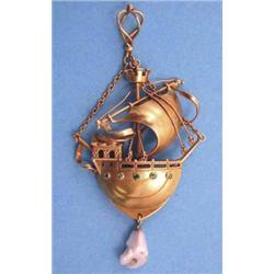 An Arts & Crafts gold pendant in the style of Bernard Cuzner designed as a galleon under sail, th...