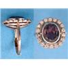 Image 1 : A white gold cluster ring set with an oval garnet bordered by small diamonds....