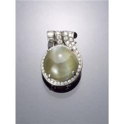 Art Deco Platinum Chrysoberyl Cat's Eye and Diamond Clip, Circa 1930, Set with a large round...