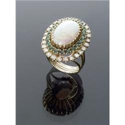 18-Karat Yellow Gold, White Opal, Diamond and Emerald Dinner Ring, Set with one oval cabochon o...