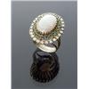 Image 1 : 18-Karat Yellow Gold, White Opal, Diamond and Emerald Dinner Ring, Set with one oval cabochon o...