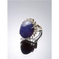 14-Karat Yellow Gold Blue Sapphire and Diamond Dinner Ring, Set with one oval high cabochon sap...