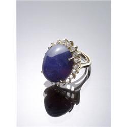 14-Karat Yellow Gold Blue Sapphire and Diamond Dinner Ring, Set with one oval high cabochon sap...