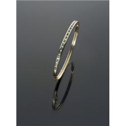 18-Karat Yellow Gold Diamond and Emerald Bangle Bracelet, The channel mount set with eighteen r...