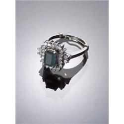 18-Karat White Gold Emerald and Diamond Dinner Ring, Set with one rectangular cut emerald weigh...