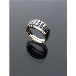 14-Karat Yellow Gold Blue Sapphire and Diamond Dinner Ring, Set with twenty-one channel set squ...