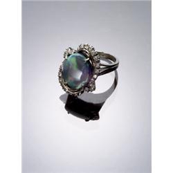 18-Karat White Gold, Black Opal and Diamond Dinner Ring, Set with one oval cabochon opal measur...