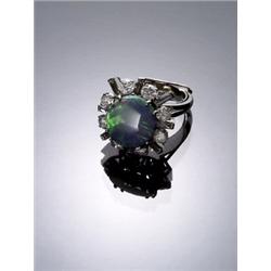 Platinum, Black Opal and Diamond Dinner Ring, Set with one oval cabochon opal measuring 14.99 x...