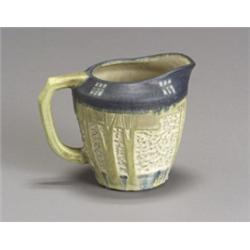 Jervis Pottery Matte Glaze Pitcher, Circa 1908-1912, Having a central frieze carved with tree...