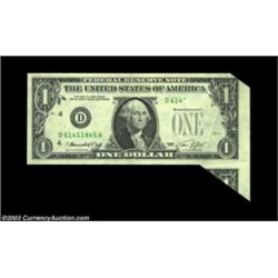 Fr. 1908-D $1 1974 Federal Reserve Note. About Uncirculated. A neat foldover error, with pieces of t