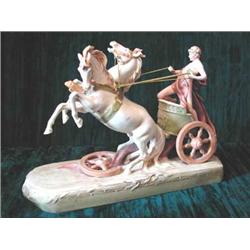 A Royal Dux porcelain figure of a charioteer and two horses raised on oblong base 40cm wide (res...