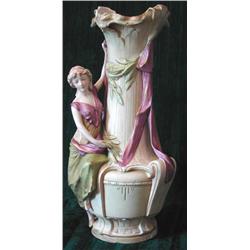 A Royal Dux porcelain vase mounted with a young female wearing purple swags, height 43cm (ILLUST...