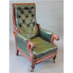 A good William IV mahogany framed button upholstered adjustable library armchair with pull-out f...