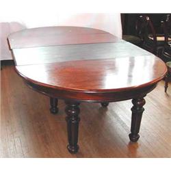 A substantial Victorian mahogany extending dining table with two extra leaves, on six turned sup...