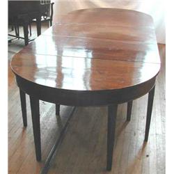 A George III mahogany D-end extending dining table with twin D-ends, two extra leaves and centra...