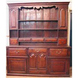 An 18th century oak Westmoreland dresser, the plate rack with small drawers and shelves flanked...