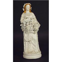 Bisque figurine of a young woman in a flowi…