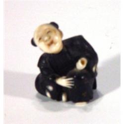 Ivory Netsuke carved as a seated gentleman …