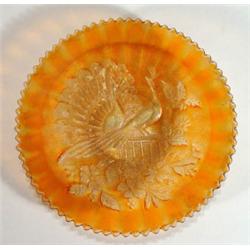 Orange carnival glass plate, impressed with…