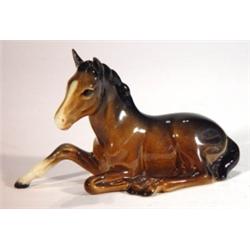 Hand painted Beswick seated brown foal, imp…