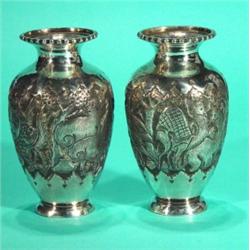 Pair of white metal vases, embossed with a …