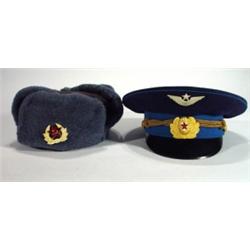 Two Russian military hats with badges…