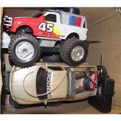 2 LARGE REMOTE TRUCKS WITH CHARGERS AND REMOTES