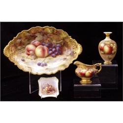 A Royal Worcester jug, date code for 1931, signed A Shuck, of helmet form with scrolling handle,...