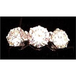 A three stone ring set with brilliant cut diamonds, centre stone measuring approximately 6.7 x 4m...