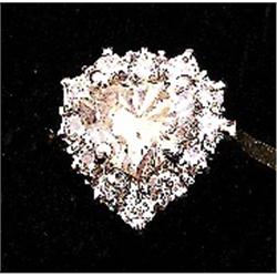 A hearts shaped cluster ring, set with centre fancy brown diamond, approx. 1.02 ct, surrounded by...
