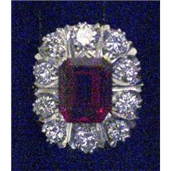 A rectangular cluster ring, set with a centre Verneuil synthetic ruby surrounded by brilliant cut...