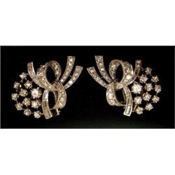 A pair of cluster ear-clips, in the form of floral sprays set with eight-cut and baguette cut dia...