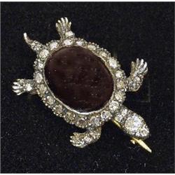 A Victorian style brooch, in the form of a turtle, with a cabachon garnet body and rose-cut diamo...