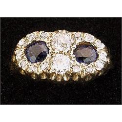An 18ct gold double cluster ring set with blue sapphires surrounded by diamonds, hallmarked Sheff...