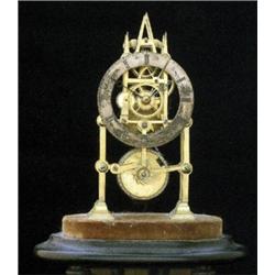 A brass skeleton clock, probably early 20th Century, the 3" brass chapter dial on a eight day mov...