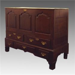 A late 18th Century oak Dowry chest, the triple plank, hinged top above a triple, ogee panelled f...