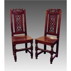 A pair of George III oak side chairs, early 19th Century, the pierced top rail and pierced rectan...