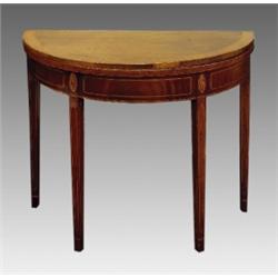 A George III mahogany and satinwood inlaid demi-lune fold over tea table, circa 1790, the crossba...