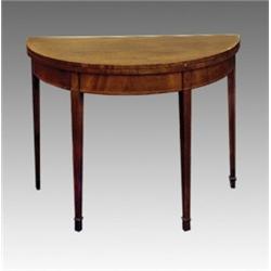 A George III mahogany demi-lune foldover card table, circa 1790, the crossbanded top above a plai...