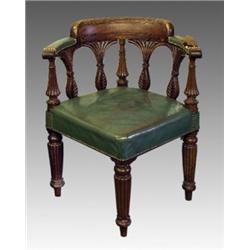 A George III mahogany corner chair, early 19th Century, the crescent elbow rests with raised back...