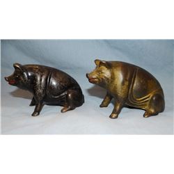 2 Sitting cast iron piggy banks, 3" h x 5" l