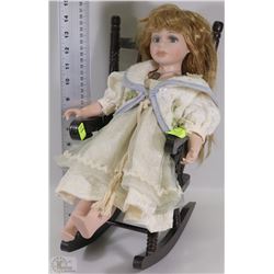 DECORATIVE PORCELAIN DOLL IN ROCKING CHAIR