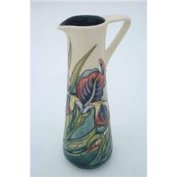 A modern Moorcroft jug, with tube-lined decoration depicting irises....
