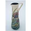 Image 1 : A modern Moorcroft jug, with tube-lined decoration depicting irises....
