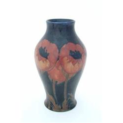 A large Moorcroft baluster-shaped poppy vase, with tube-lined poppy decoration, red on a dark-blu...