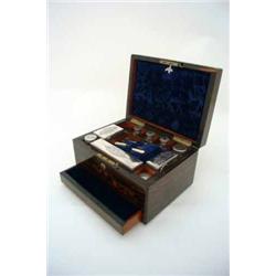 A Victorian coromandel travelling toilet set, having fitted interior with plate-mounted perfume b...