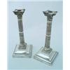 Image 1 : A pair of silver candlesticks, the square-shaped sloping bases with beaded bands, supporting reed...
