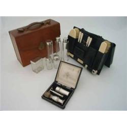 A gentleman's travelling toilet set, in brown leather case, with lift-out section, fitted ivory b...