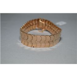 Lady's vintage14kt rose gold custom made bracelet with safety chain, approximately 7" in length. Ret