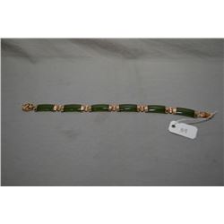 Lady's 14kt yellow gold and Chinese jade bracelet 7 1/2" in length